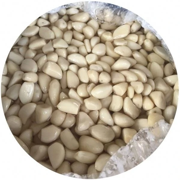 Salted peeled white garlic cloves in brine in drums